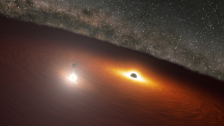 Этот рисунок иллюстрирует прохождение малой чёрной дыры через аккреционный диск большой.